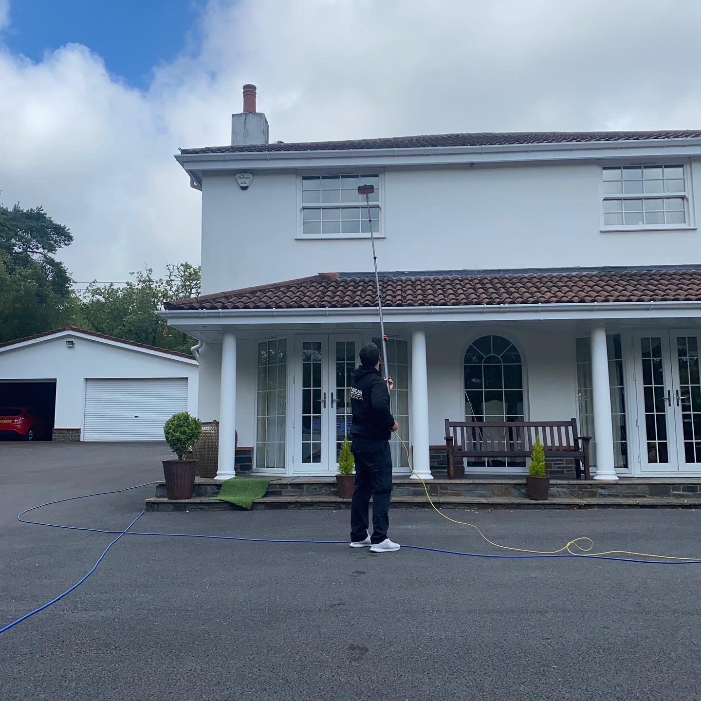 EverClean cleaning the windows of a white house